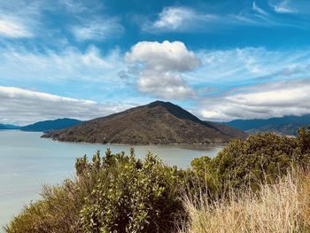 Scenic view of land and mountains against sky