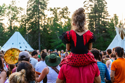 Rear view of friends enjoying at music concert