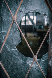 Close-up of broken glass window