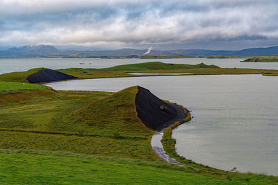 Scenic view of green land against sky