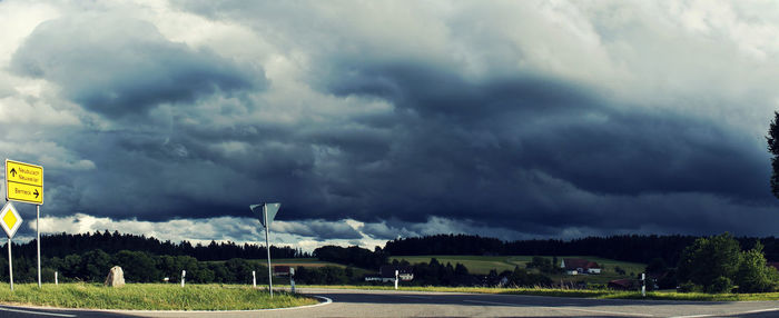 Panoramic view of storm clouds over road