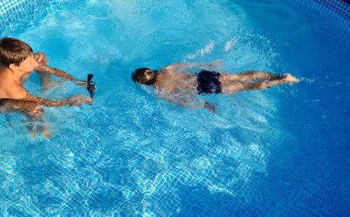 High angle view of people swimming in pool