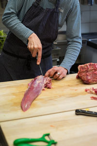 Man preparing food on cutting board