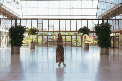 Portrait of woman standing on tiled floor