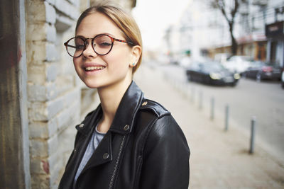 Portrait of smiling young woman in city