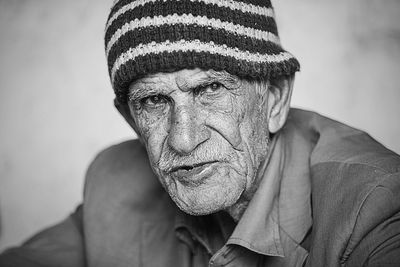 Close-up portrait of senior man wearing knit hat