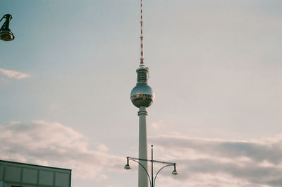 Low angle view of communications tower against sky