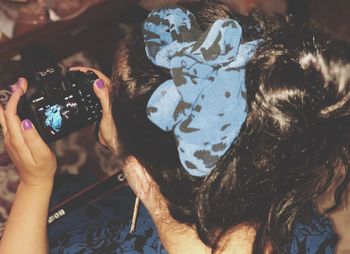 Midsection of woman photographing with mobile phone