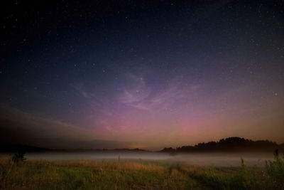 Scenic view of landscape against sky at night