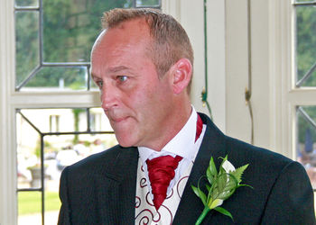 Portrait of man with red flowers