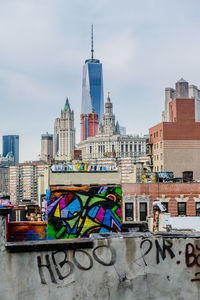 Low angle view of one world trade center amidst buildings in city