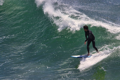 Full length of man surfing in sea