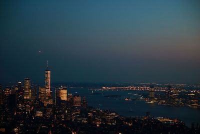 High angle view of illuminated buildings against sky at night