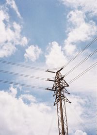 Low angle view of electricity pylon against sky