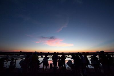 Silhouette people at sunset