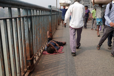 Rear view of people walking on street in city