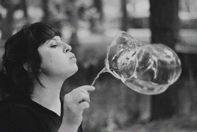 Close-up of woman blowing bubbles