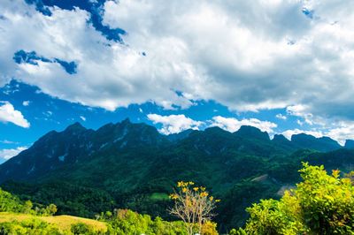 Scenic view of mountains against cloudy sky