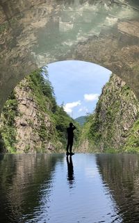 Rear view of man standing in cave