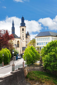 Trees and buildings against sky