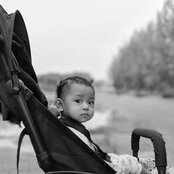 Portrait of cute baby girl in carriage