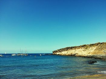 Scenic view of sea against clear blue sky