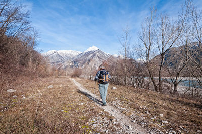 Rear view of man standing on snow covered landscape