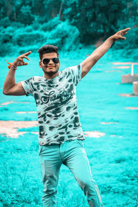 Young man wearing sunglasses in swimming pool