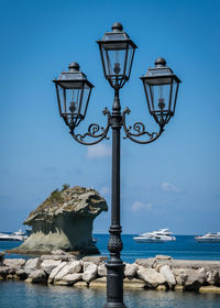 Low angle view of street light against sky