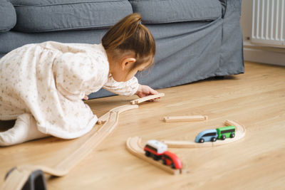 Cute girl playing with toy train