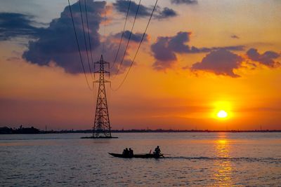 Silhouette ship on sea against sky during sunset