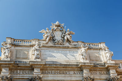 Low angle view of sculpture against blue sky