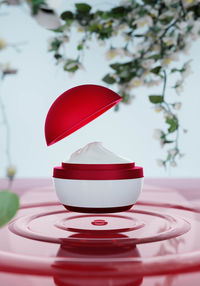 Close-up of red coffee cup on table