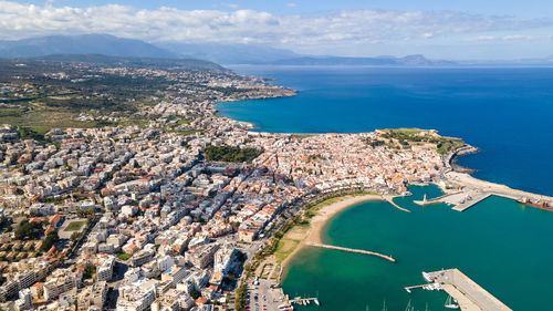 High angle view of sea and buildings against sky