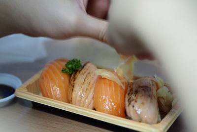 Close-up of hand holding ice cream in plate