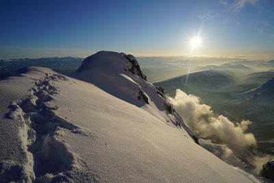 Scenic view of snow mountains against sky during sunset