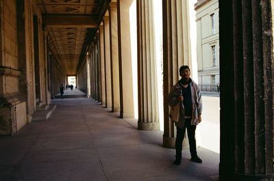 Full length of man standing in corridor of building