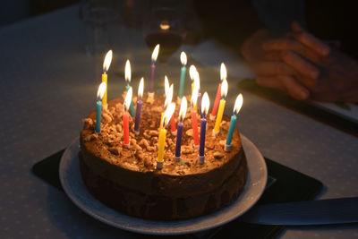 Close-up of lit birthday candles on table
