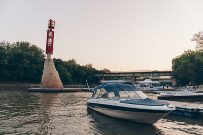 Boat moored on shore against clear sky