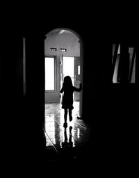 Silhouette man walking in corridor