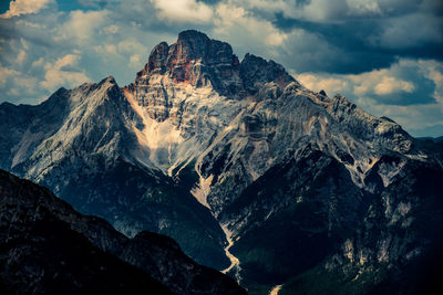 Low angle view of snowcapped mountains against sky