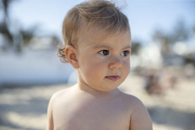 Close-up of cute baby looking away