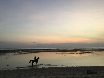 Scenic view of beach against sky during sunset