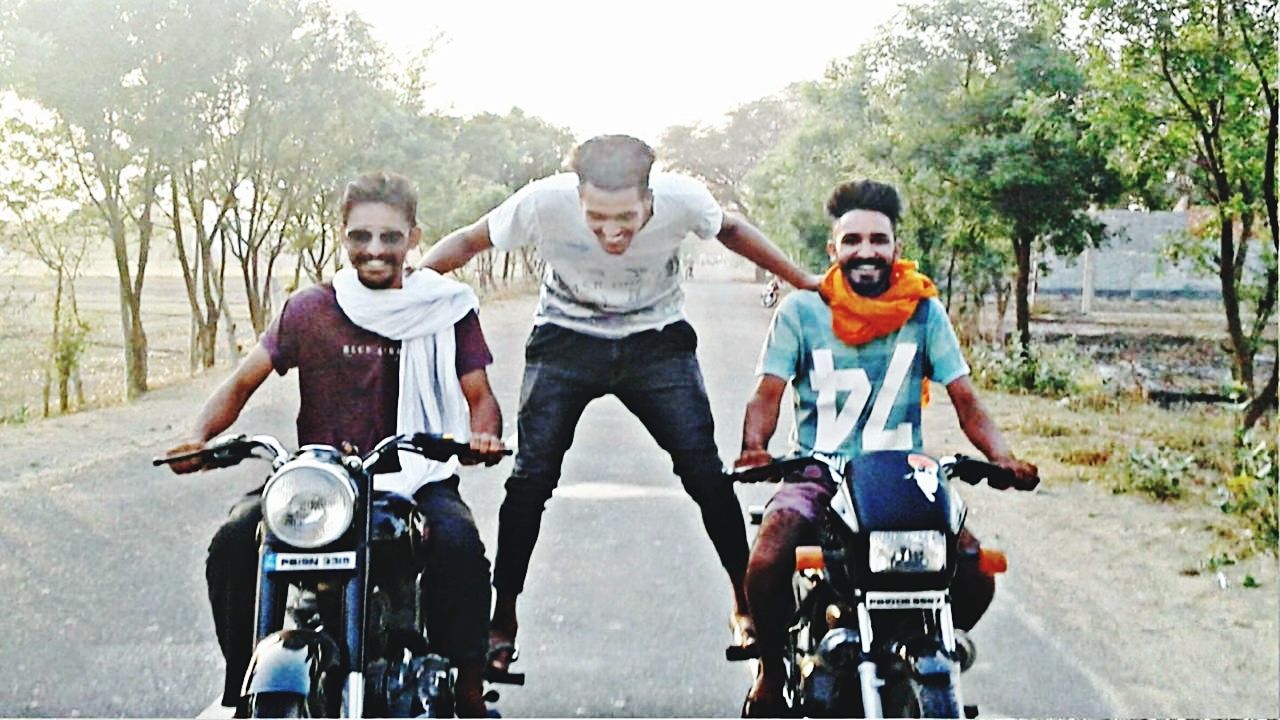 group of people, transportation, adult, men, togetherness, friendship, full length, sports, small group of people, leisure activity, day, bonding, casual clothing, helmet, young adult, road, motorcycle, front view, happiness, sports helmet, nature, motorcycling, emotion, tree, headwear, women, bicycle, fun, smiling, lifestyles, vehicle, female, mode of transportation, cycling, enjoyment, outdoors, motion, activity, carefree, clothing, child, person, riding, on the move, sports equipment, adventure, portrait, crash helmet, travel, sunglasses, road trip