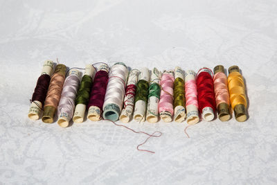 Close-up of multi colored thread spools on table