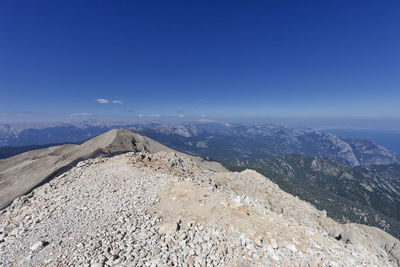 Scenic view of mountains against blue sky