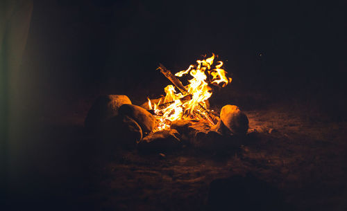 Close-up of bonfire on field at night