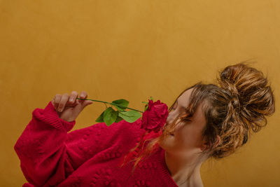 Close-up of woman holding rose