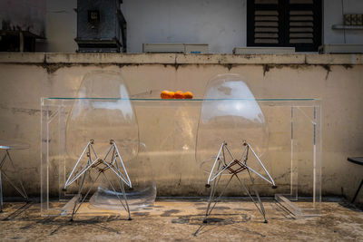 Empty chairs against abandoned building