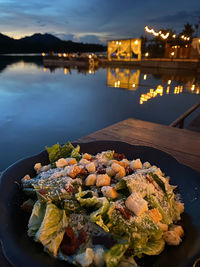 Close-up of food on table in lake at night